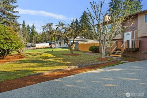a view of yard with swimming pool and trees