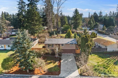 a view of a house with a yard and sitting area