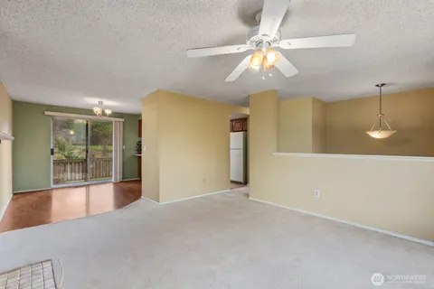 a view of a livingroom with a chandelier furniture and windows