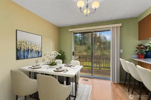 a view of a dining room with furniture wooden floor and a chandelier