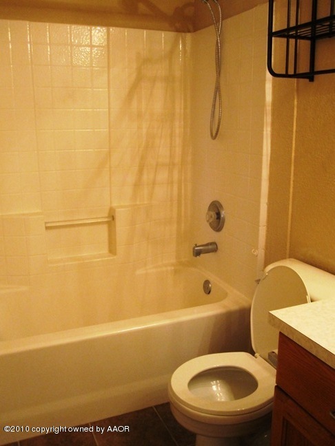 1140 Shasta Drive Amarillo, TX 79110 - Photo 15 of 23 a bathroom with a toilet a sink and bathtub