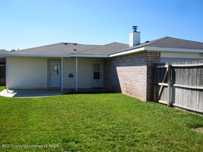 1140 Shasta Drive Amarillo, TX 79110 - Photo 2 of 23 a front view of a house with a yard and garage