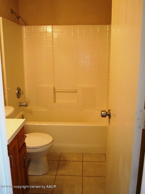 1140 Shasta Drive Amarillo, TX 79110 - Photo 21 of 23 a bathroom with a toilet and a shower