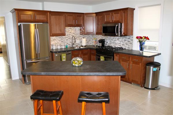 676 Sumner Avenue Springfield, MA 01108 - Photo 1 of 15 a kitchen with stainless steel appliances granite countertop a stove refrigerator and microwave