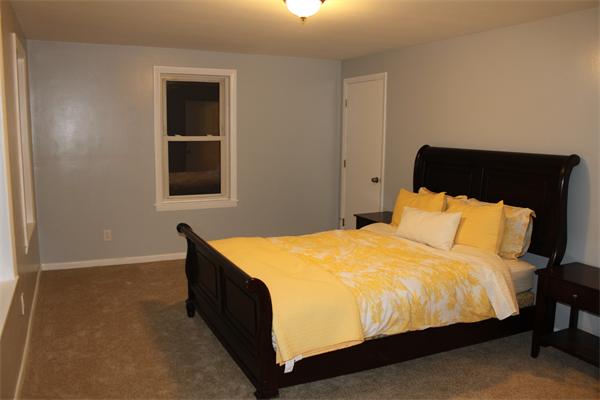 676 Sumner Avenue Springfield, MA 01108 - Photo 11 of 15 a bedroom with a bed and wall painting