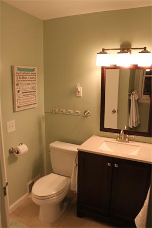 676 Sumner Avenue Springfield, MA 01108 - Photo 13 of 15 a bathroom with a granite countertop sink toilet and mirror