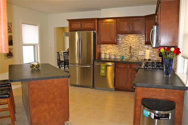 676 Sumner Avenue Springfield, MA 01108 - Photo 4 of 15 a kitchen with kitchen island a counter top space appliances and a window