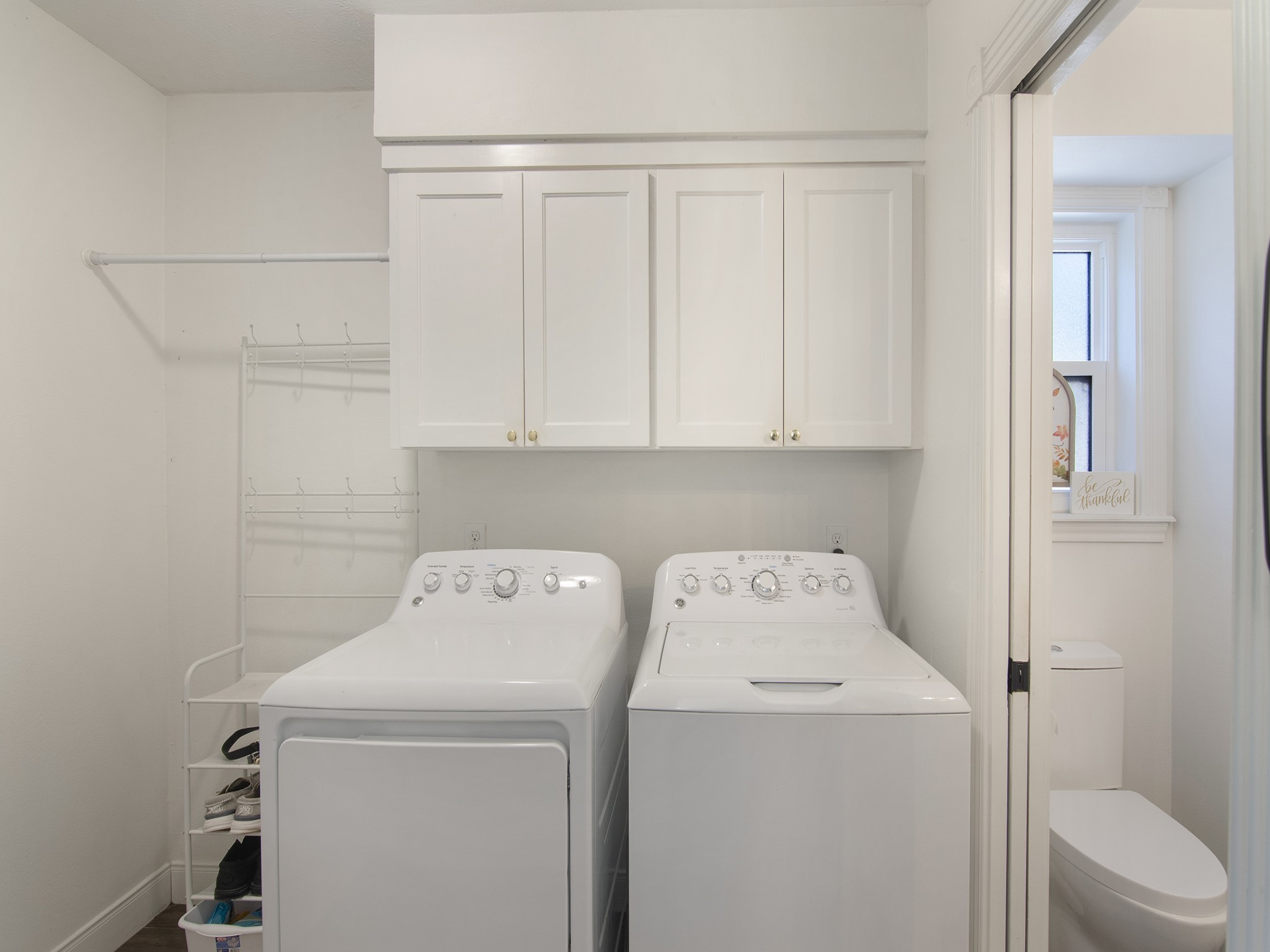 532 Raleigh Drive Conroe, TX 77302 - Photo 19 of 40 Well-appointed laundry area with storage cabinets. A pocket door leads to guest bathroom, which features a window for natural light.