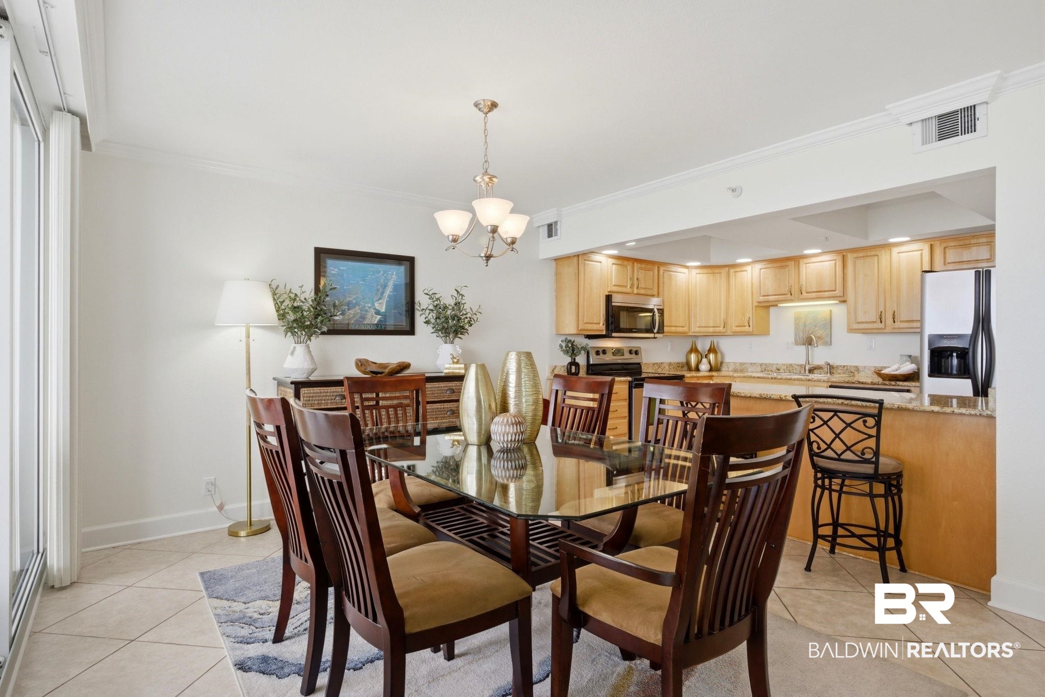 16284 Perdido Key Drive, Unit 912 Perdido Key, FL 32507 - Photo 22 of 49 Dining room featuring suspended lighting, light tile patterned flooring, and crown molding