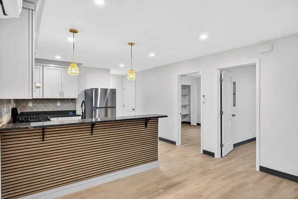 a kitchen with stainless steel appliances granite countertop a refrigerator a sink and a oven