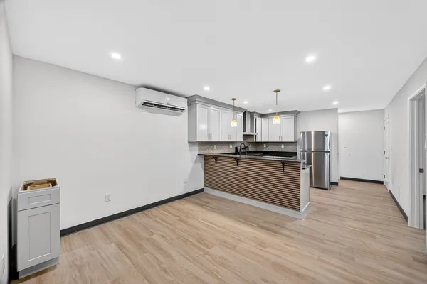 a kitchen with stainless steel appliances granite countertop a refrigerator and a sink