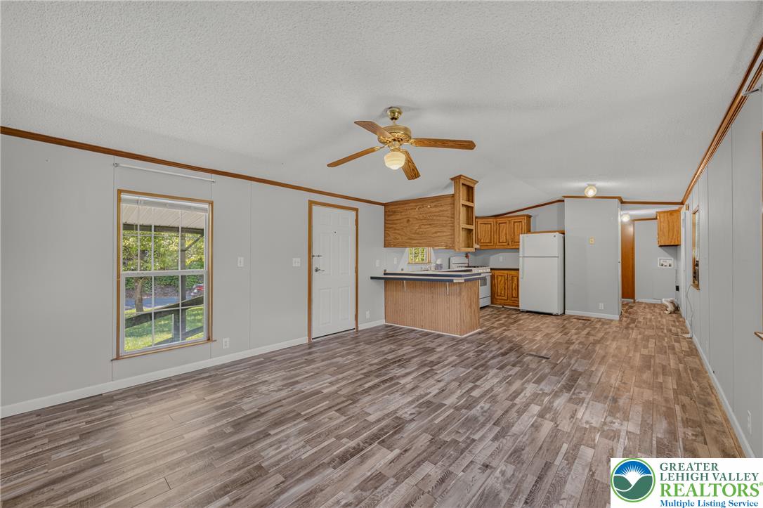2674 Williams Road Danielsville, PA 18038 - Photo 30 of 31 An open floorplan seamlessly connects the living area and kitchen, featuring durable plank flooring and a functional breakfast bar.