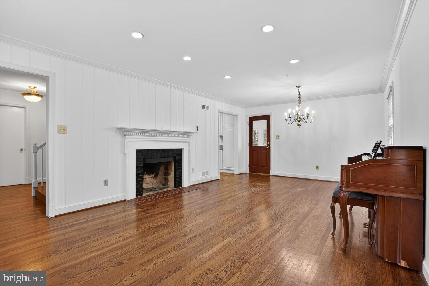 2420 Cameron Mills Road Alexandria, VA 22302 - Photo 11 of 45 a view of an empty room with wooden floor and a fireplace
