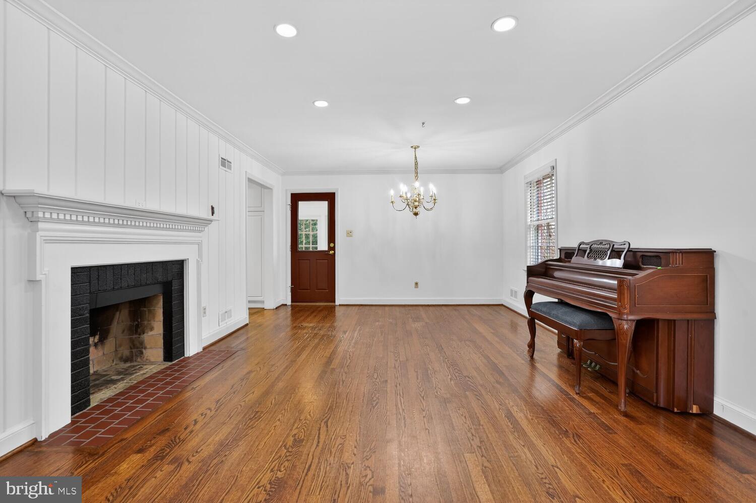 2420 Cameron Mills Road Alexandria, VA 22302 - Photo 15 of 45 a view of a room with wooden floor and fireplace