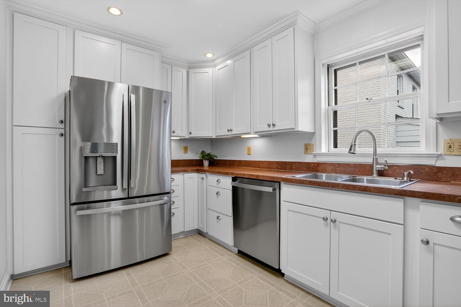 2420 Cameron Mills Road Alexandria, VA 22302 - Photo 18 of 45 a kitchen with appliances a sink and a counter top space