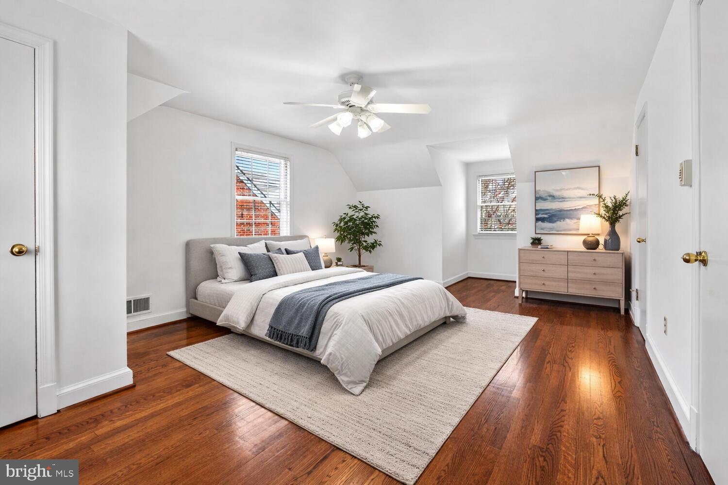 2420 Cameron Mills Road Alexandria, VA 22302 - Photo 26 of 45 a spacious bedroom with a bed and wooden floor