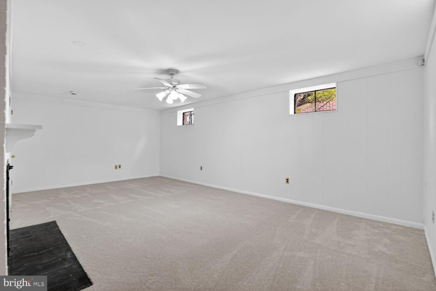 2420 Cameron Mills Road Alexandria, VA 22302 - Photo 34 of 45 an empty room with a chandelier fan and windows