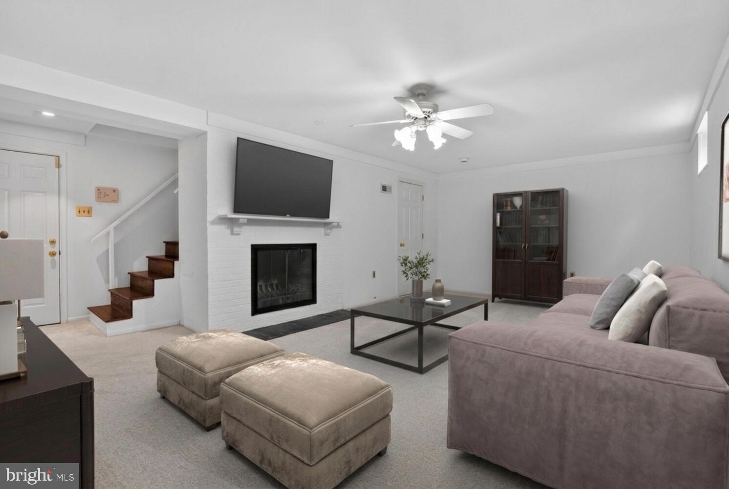 2420 Cameron Mills Road Alexandria, VA 22302 - Photo 35 of 45 a living room with furniture a flat screen tv and a fireplace