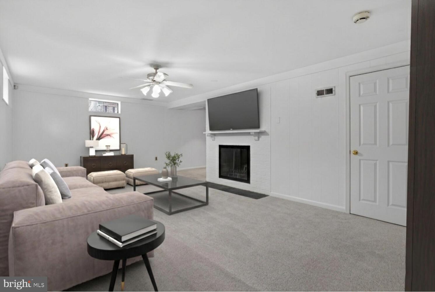2420 Cameron Mills Road Alexandria, VA 22302 - Photo 39 of 45 a living room with furniture a fireplace and a flat screen tv