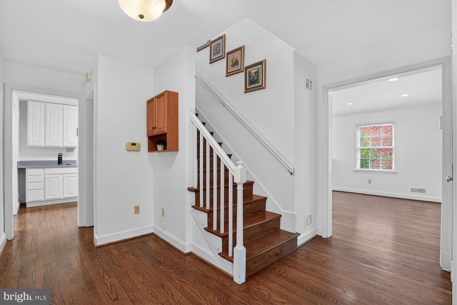 2420 Cameron Mills Road Alexandria, VA 22302 - Photo 6 of 45 a view of a hallway with wooden floor and entryway