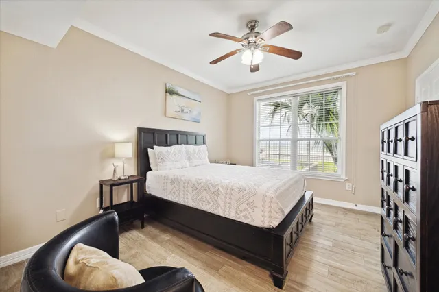 a spacious bedroom with a bed and a chandelier