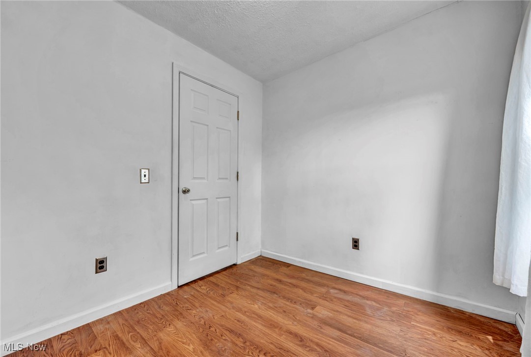 39020 Center Ridge Road North Ridgeville, OH 44039 - Photo 23 of 30 Spare room with a textured ceiling and light wood-type flooring