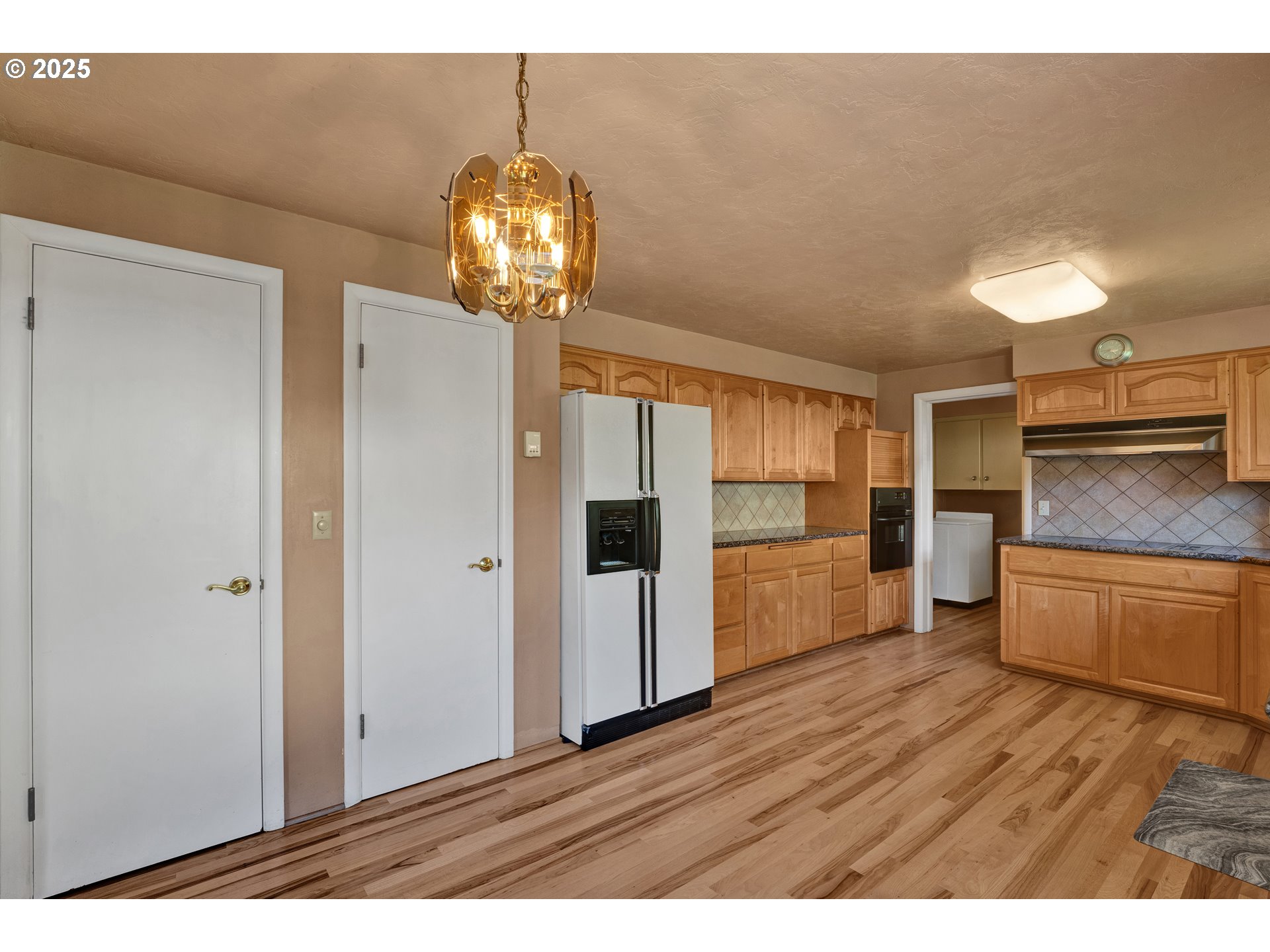 925 Ascot Drive Eugene, OR 97401 - Photo 11 of 44 a kitchen with stainless steel appliances granite countertop a refrigerator and a stove top oven