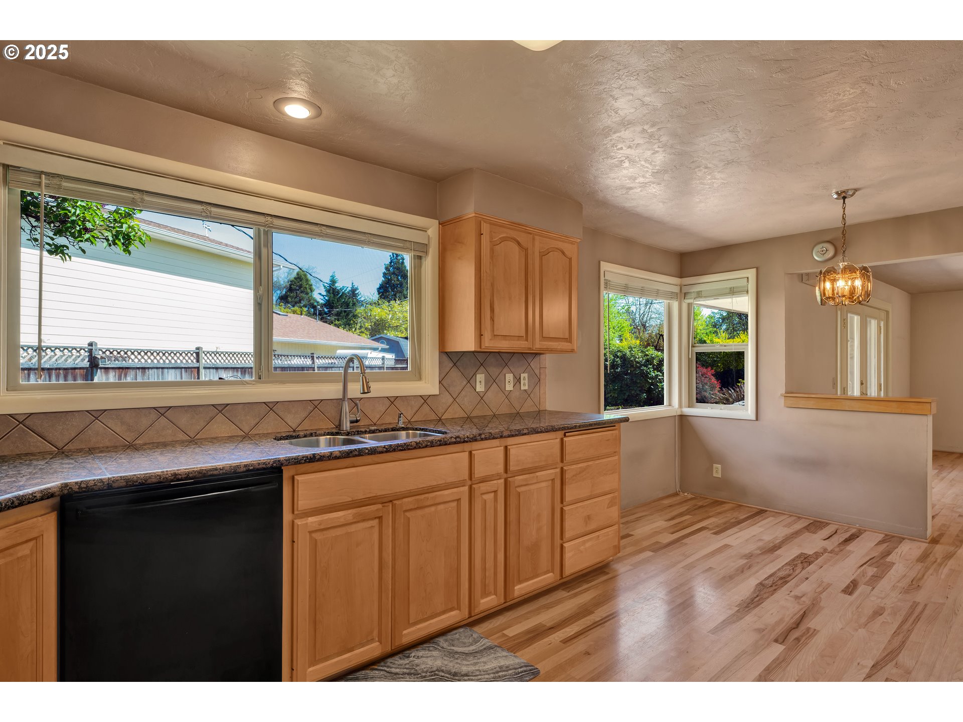 925 Ascot Drive Eugene, OR 97401 - Photo 13 of 44 a kitchen with a sink a window and cabinets