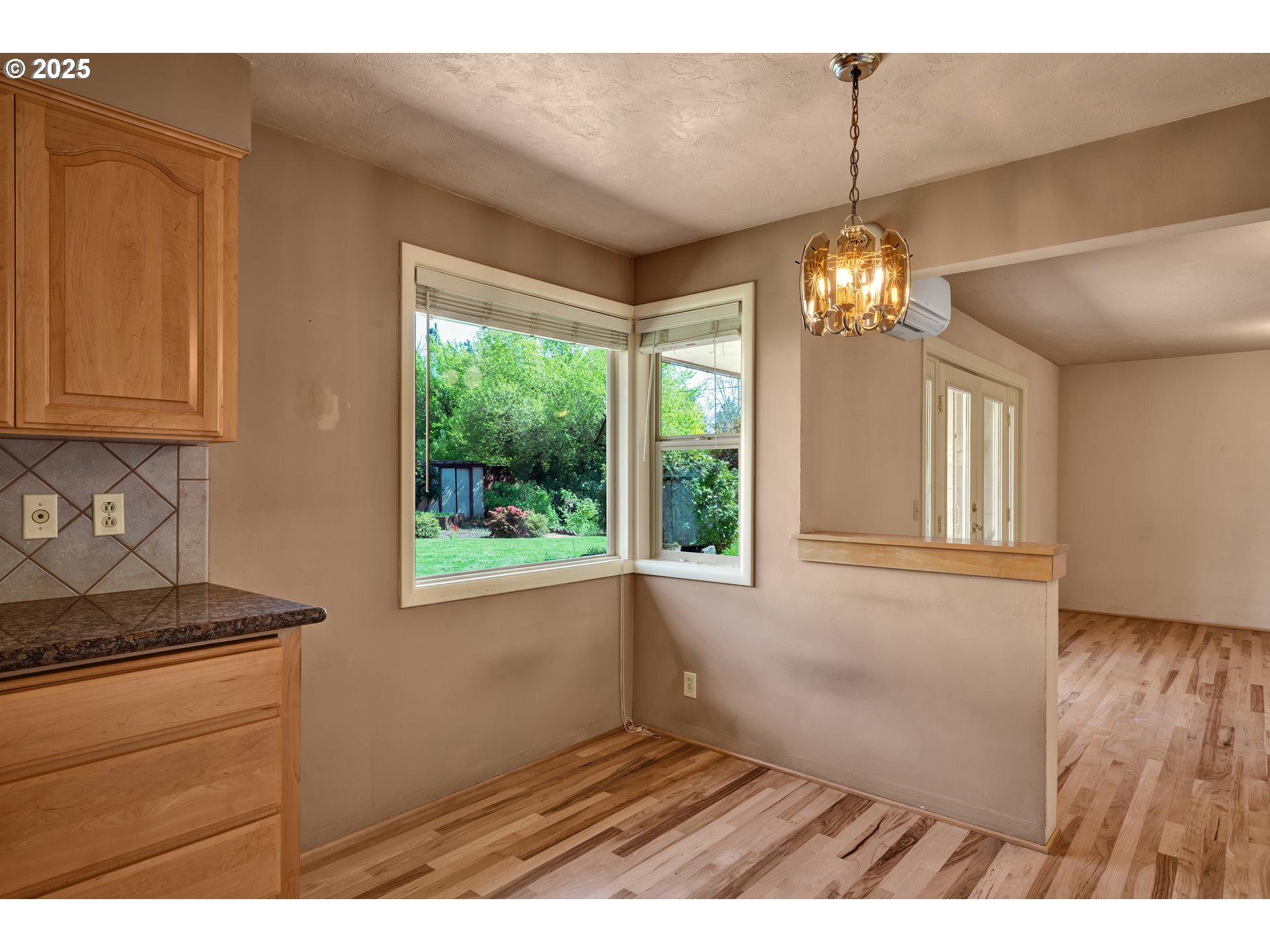 925 Ascot Drive Eugene, OR 97401 - Photo 14 of 44 a view of an empty room with wooden floor and a window
