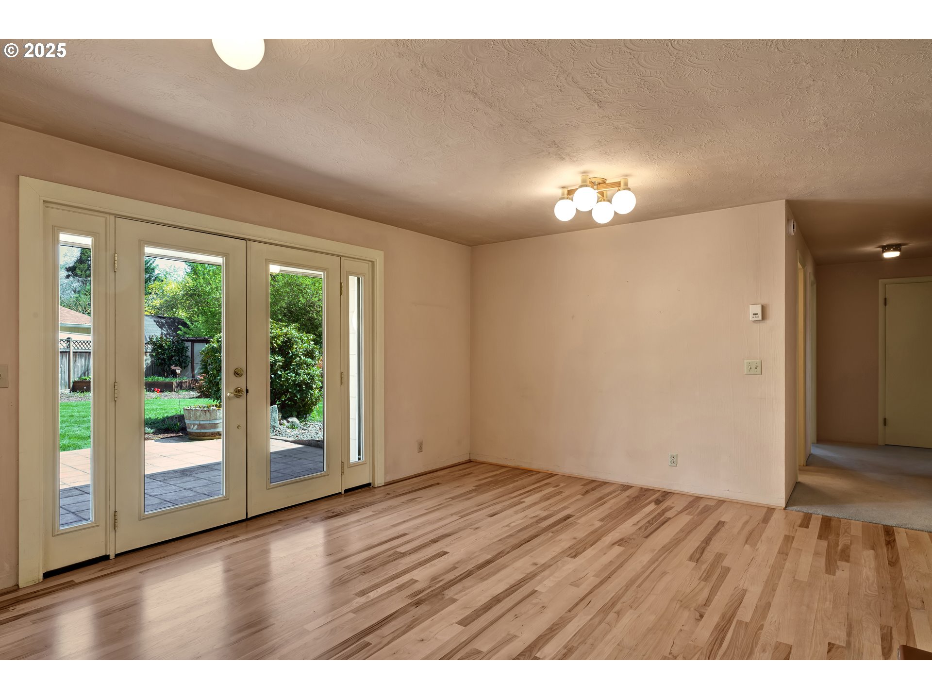 925 Ascot Drive Eugene, OR 97401 - Photo 15 of 44 a view of an empty room with wooden floor and a window