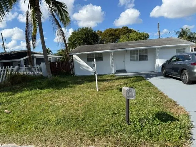 a front view of a house with a yard table and chairs