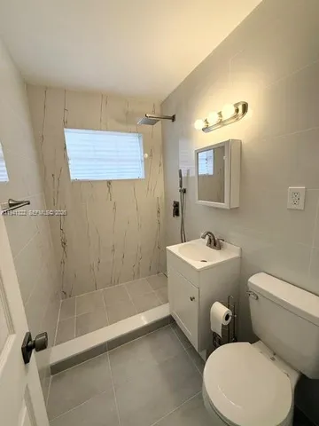 a white toilet sitting next to a bathroom sink