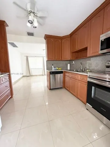 a kitchen with stainless steel appliances granite countertop a sink and cabinets