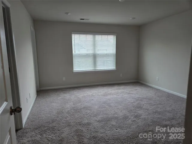 a view of a room with racks on the wall and a window