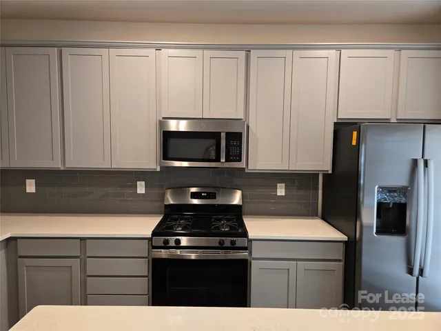 a kitchen with a stove and a microwave