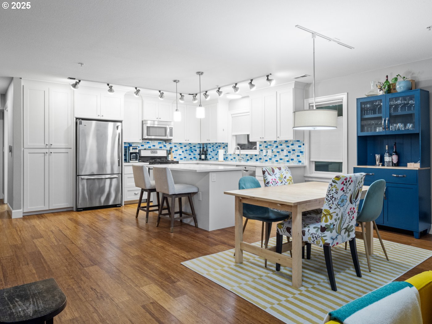 2013 Northeast 10th Avenue, Unit E Portland, OR 97212 - Photo 10 of 30 a room with stainless steel appliances kitchen island granite countertop furniture wooden floor and a kitchen view