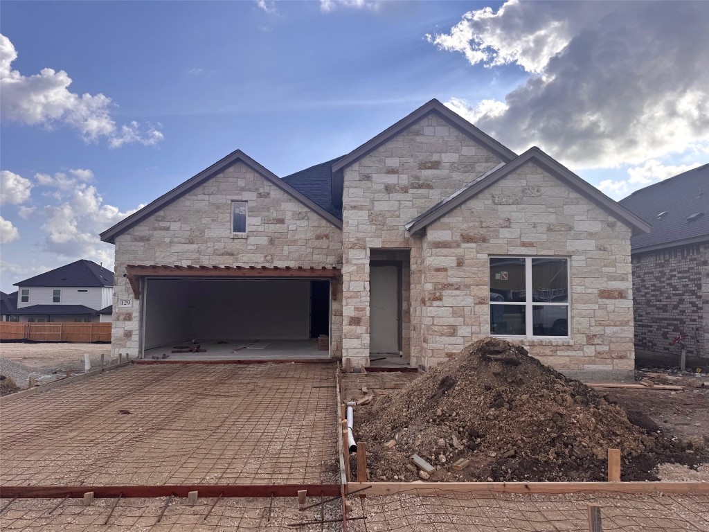 a front view of a house with plants
