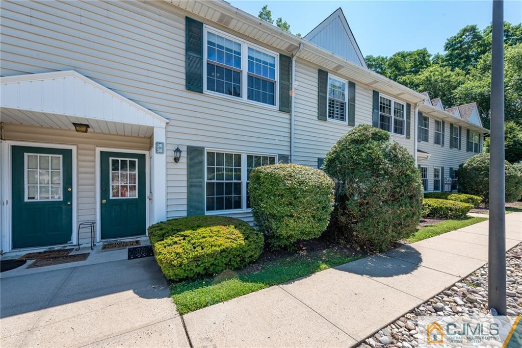 36 Hanover Square, Unit E Middlesex, NJ 08846 - Photo 2 of 23 a view of a house with small garden plants and large tree