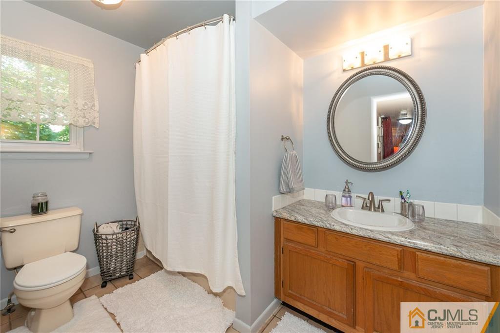 36 Hanover Square, Unit E Middlesex, NJ 08846 - Photo 11 of 23 a bathroom with a toilet a sink and a mirror