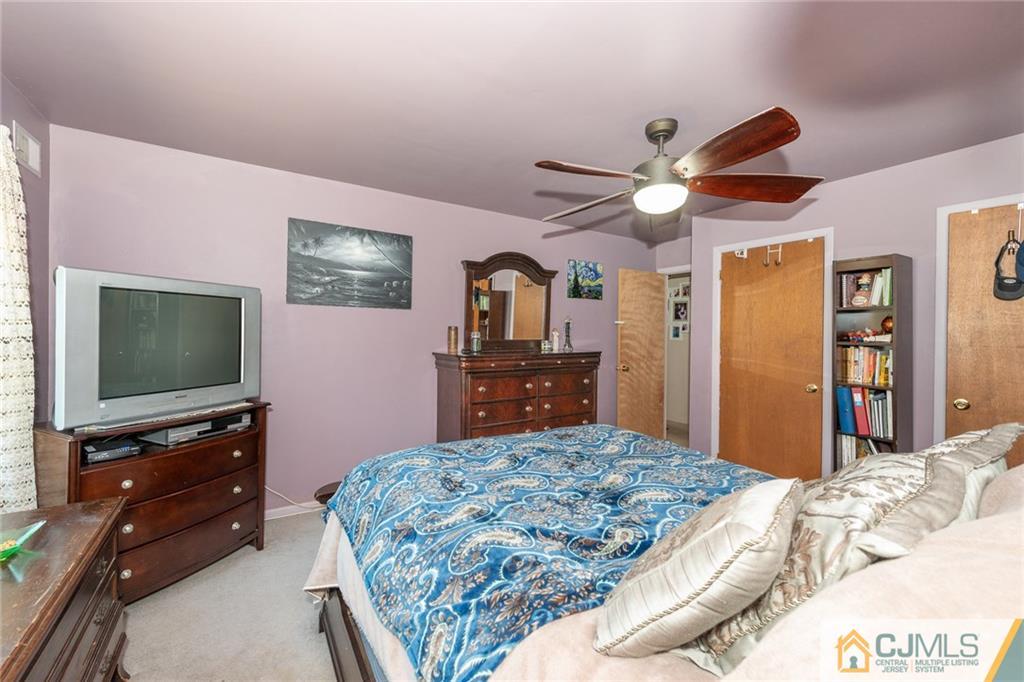 36 Hanover Square, Unit E Middlesex, NJ 08846 - Photo 13 of 23 a bedroom with a bed and a flat screen tv