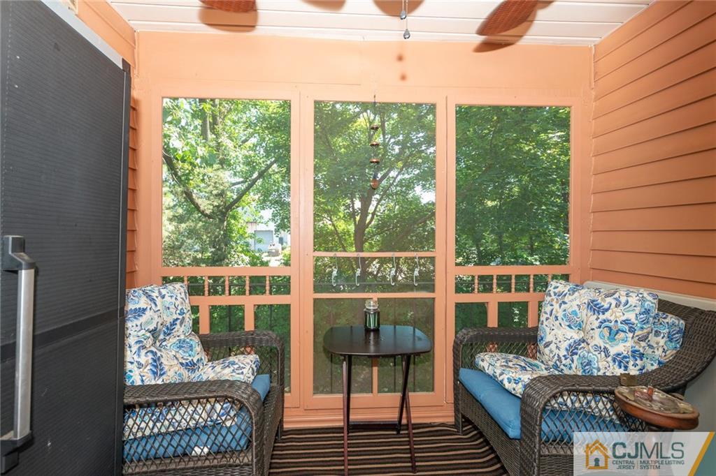 36 Hanover Square, Unit E Middlesex, NJ 08846 - Photo 18 of 23 a living room with furniture and a floor to ceiling window