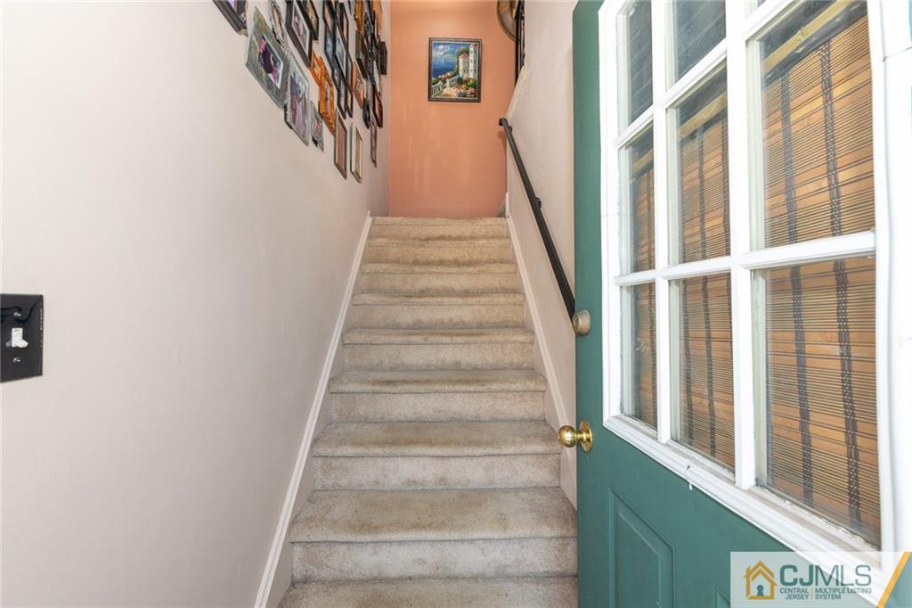 36 Hanover Square, Unit E Middlesex, NJ 08846 - Photo 3 of 23 a view of staircase with lots of frames on wall