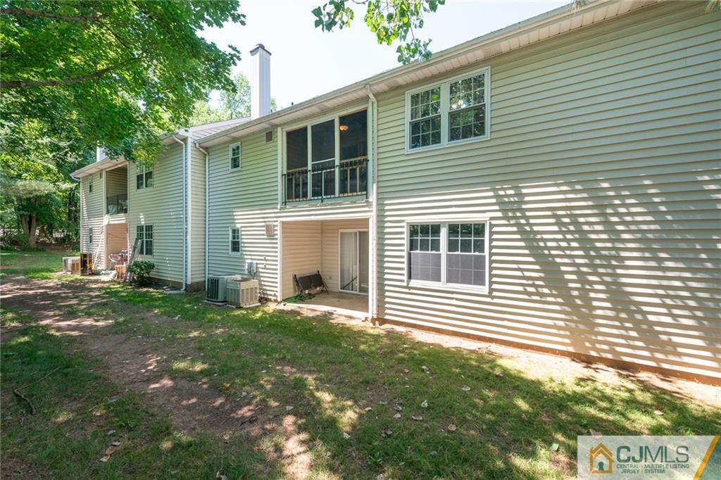 36 Hanover Square, Unit E Middlesex, NJ 08846 - Photo 21 of 23 a front view of a house with a yard