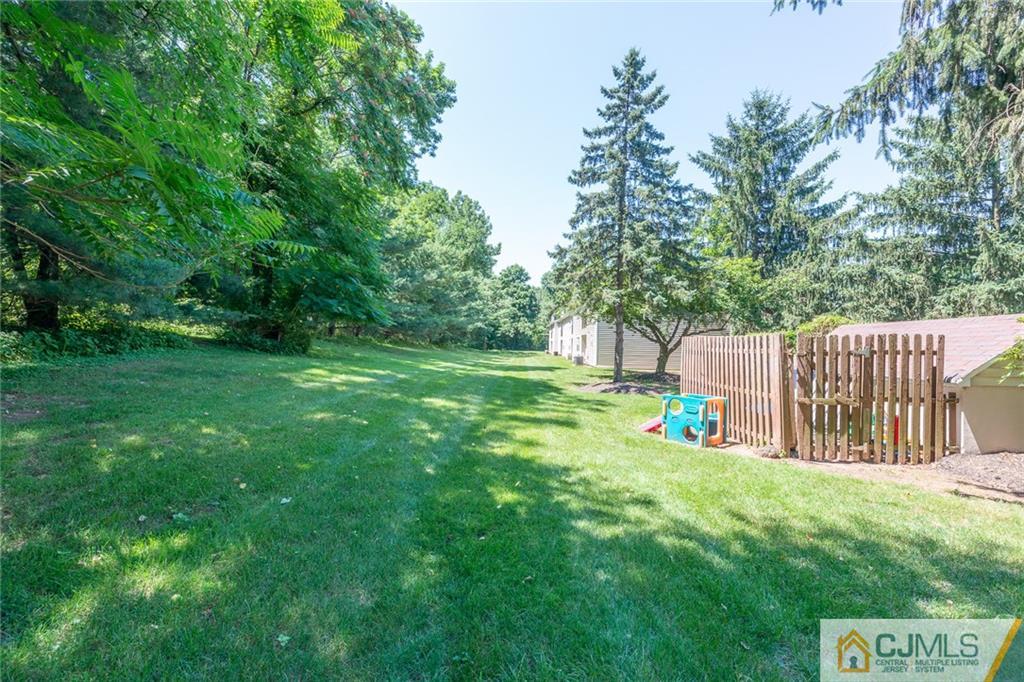 36 Hanover Square, Unit E Middlesex, NJ 08846 - Photo 22 of 23 a view of a garden with wooden fence