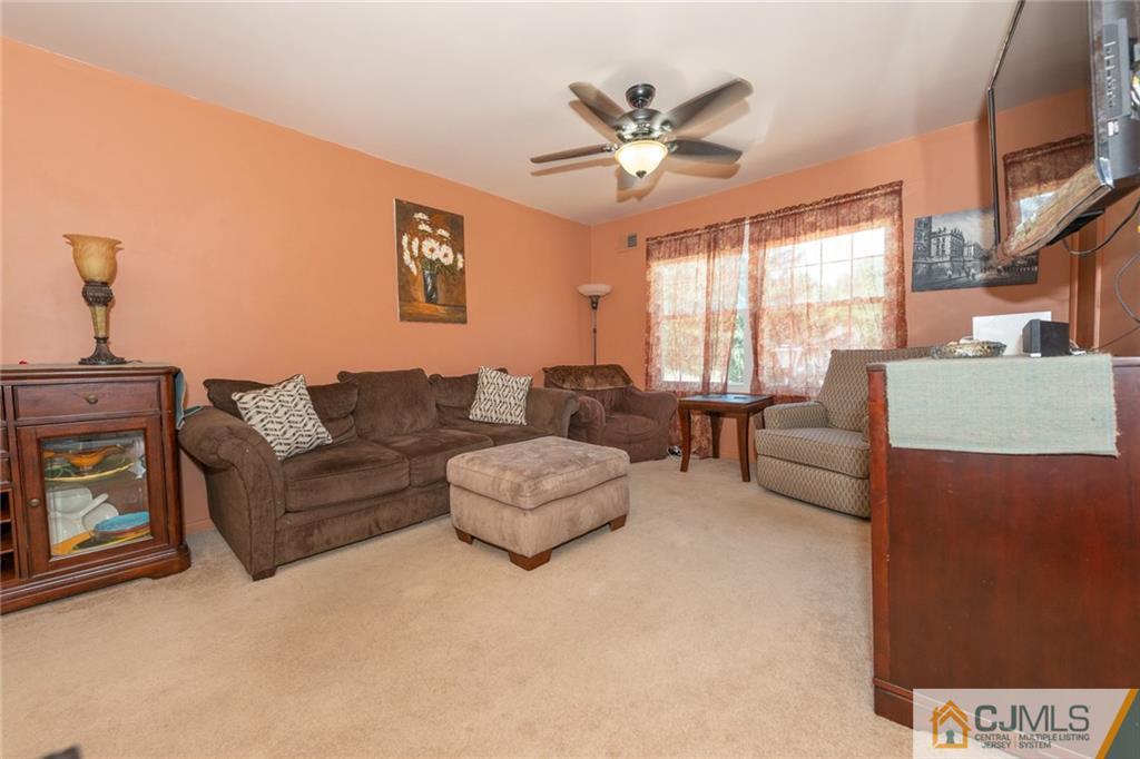 36 Hanover Square, Unit E Middlesex, NJ 08846 - Photo 4 of 23 a living room with furniture and a large window
