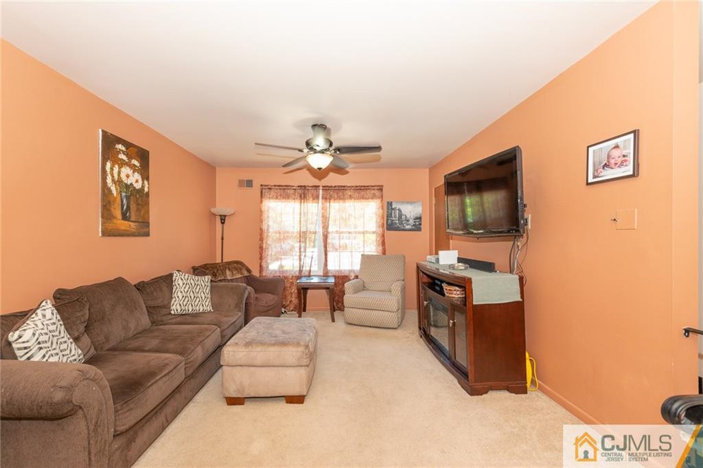36 Hanover Square, Unit E Middlesex, NJ 08846 - Photo 5 of 23 a living room with furniture and a flat screen tv