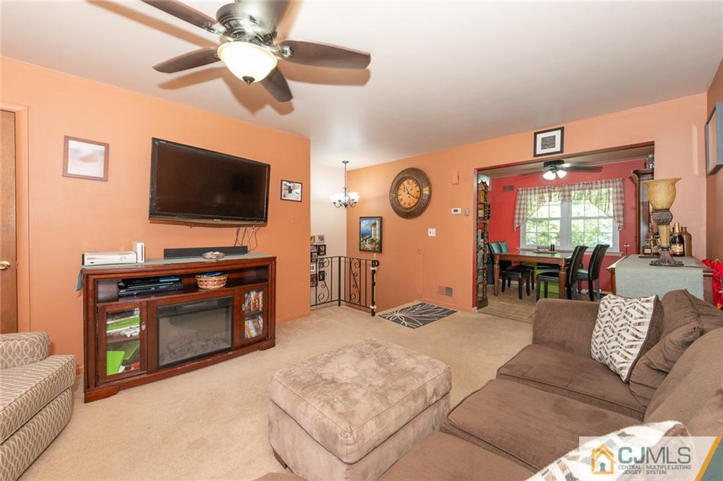 36 Hanover Square, Unit E Middlesex, NJ 08846 - Photo 7 of 23 a living room with furniture and a flat screen tv