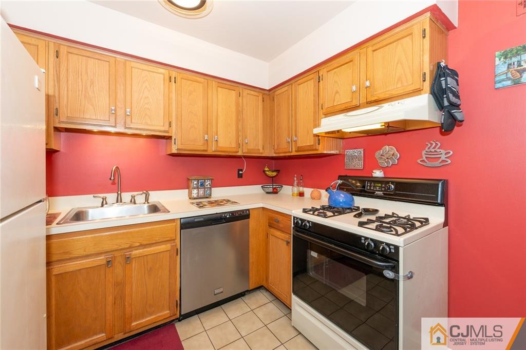 36 Hanover Square, Unit E Middlesex, NJ 08846 - Photo 9 of 23 a kitchen with stainless steel appliances granite countertop a sink stove and cabinets