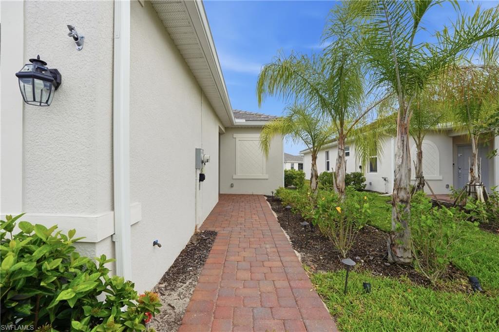 2215 Dragonfruit Way Naples, FL 34120 - Photo 3 of 38 a view of a pathway with house on both side