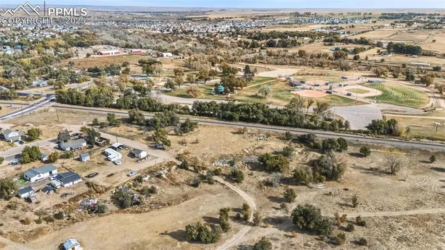 an aerial view of residential houses with wooden fence